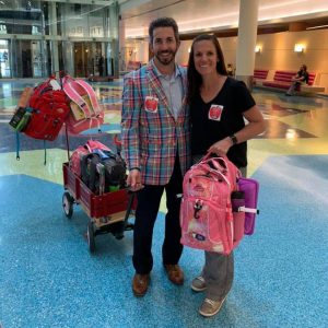 A photo of the Zimmermans at the hospital with bags to deliver