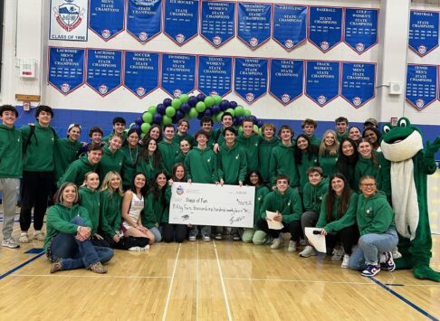 Cherry Creek kids group photo with large check and the Bags of Fun mascot.